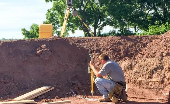 Man laying out concrete foundation