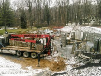 Setting forms to pour concrete walls at a new house site.