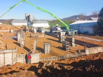 Pouring concrete for walls for an equipment shed building
