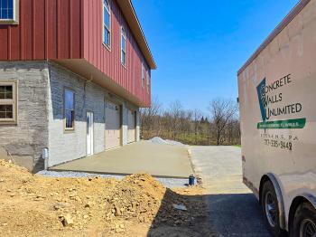 concrete slab in front of a bank barn forebay